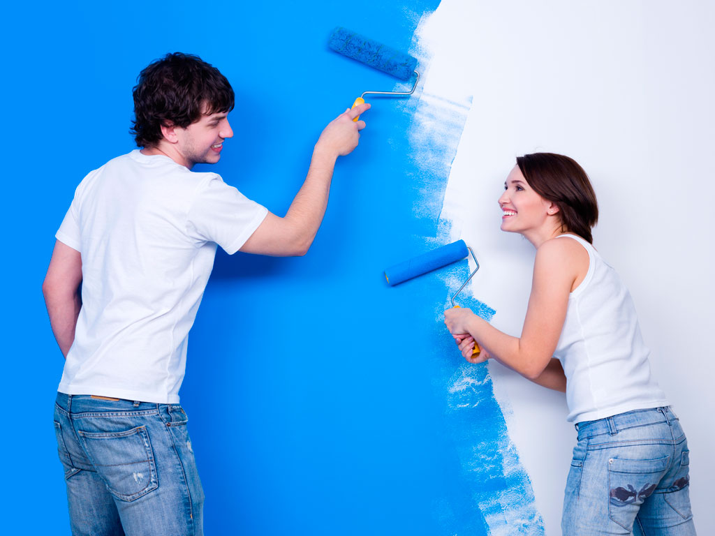 Couple painting a home